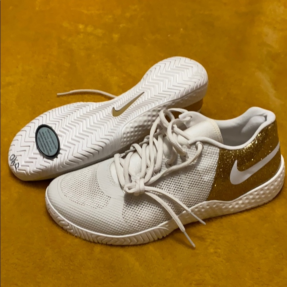 Woman’s size 11 white Nikes with gold glitter